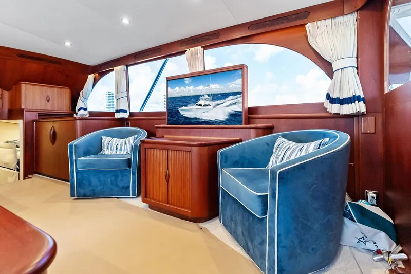 Nic-nac Yacht Photos Pics Luxurious 1977 Merritt Sportfish yacht interior with blue armchairs and elegant wood paneling.