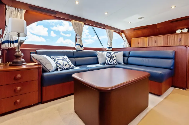 Nic-nac Yacht Photos Pics Luxurious 1977 Merritt Sportfish yacht interior with blue leather seating and elegant wood finishes.