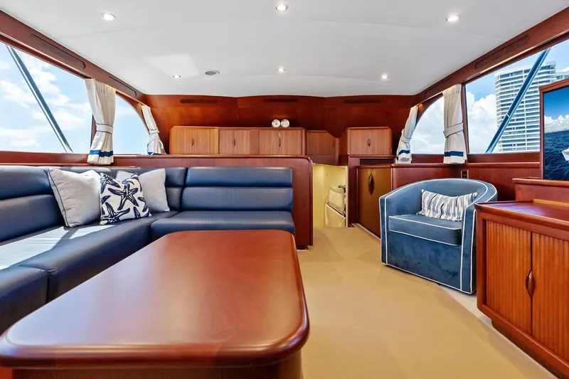 Nic-nac Yacht Photos Pics Luxurious 1977 Merritt Sportfish yacht interior with elegant seating and wooden accents.