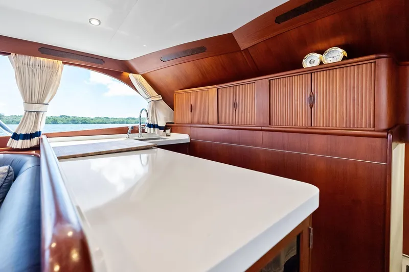 Nic-nac Yacht Photos Pics Luxurious interior of a 1977 Merritt Sportfish yacht with elegant wood cabinetry and modern fixtures.