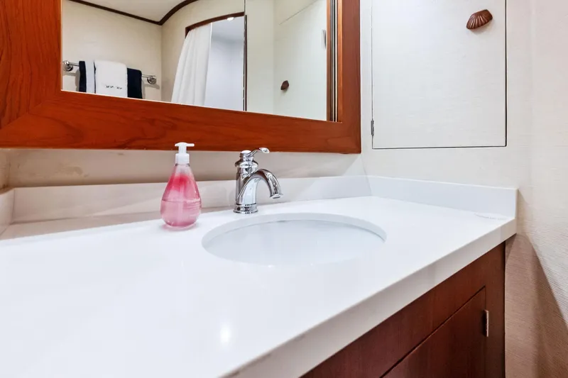 Nic-nac Yacht Photos Pics Bathroom vanity on 1977 Merritt Sportfish yacht with mirror and soap dispenser.