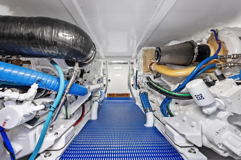 Nic-nac Yacht Photos Pics Engine room of a 1977 Merritt Sportfish boat with blue and black hoses.