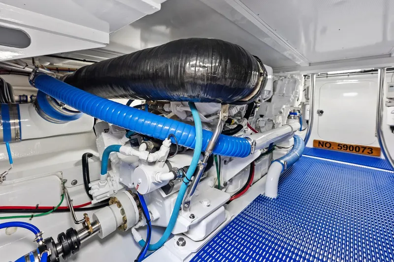 Nic-nac Yacht Photos Pics Engine room of a 1977 Merritt Sportfish boat with blue hoses and machinery.