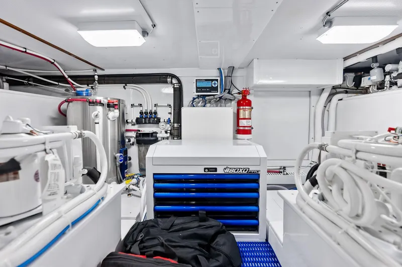 Nic-nac Yacht Photos Pics Engine room of a 1977 Merritt Sportfish boat, featuring organized tools and equipment.