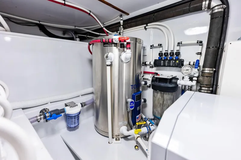 Nic-nac Yacht Photos Pics Engine room of a 1977 Merritt Sportfish boat with modern plumbing and filtration system.