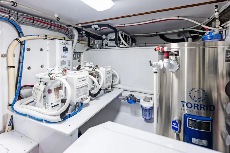 Nic-nac Yacht Photos Pics Engine room of a 1977 Merritt Sportfish yacht with modern equipment and piping.