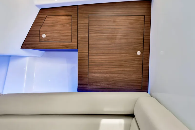  Yacht Photos Pics Interior of 2023 Boston Whaler 350 Realm with wooden cabinetry and cushioned seating.