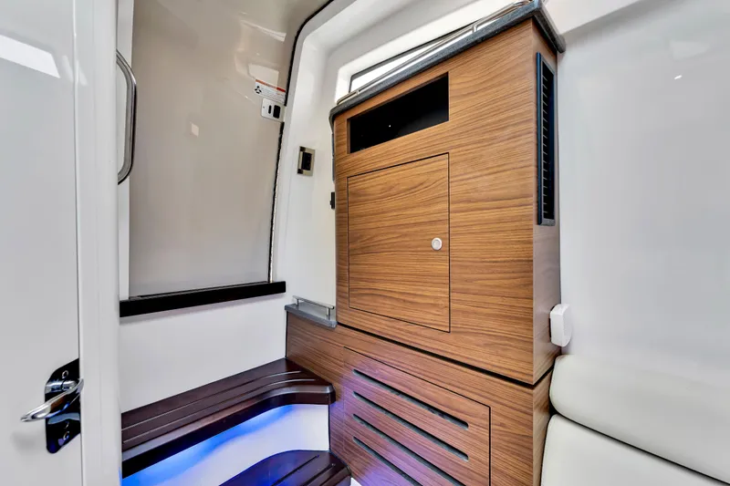  Yacht Photos Pics 2023 Boston Whaler 350 Realm interior with sleek wood cabinetry and modern design.