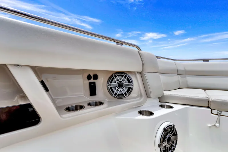  Yacht Photos Pics 2023 Boston Whaler 350 Realm interior with speakers and cup holders under a clear blue sky.