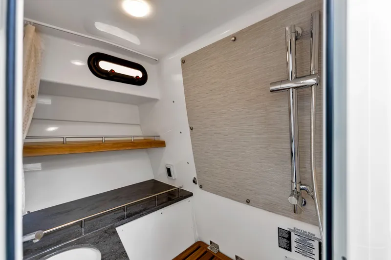  Yacht Photos Pics 2023 Boston Whaler 350 Realm interior bathroom with modern shower and sleek design.