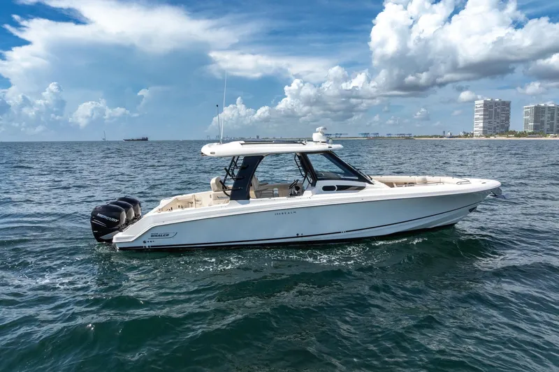  Yacht Photos Pics 2023 Boston Whaler 350 Realm boat cruising on open water under a cloudy sky.