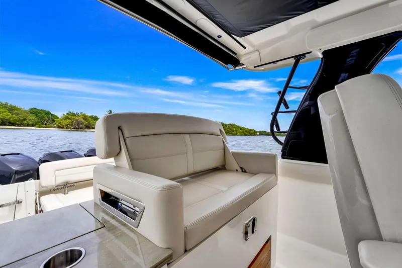  Yacht Photos Pics 2023 Boston Whaler 350 Realm interior with luxurious seating and scenic water view.