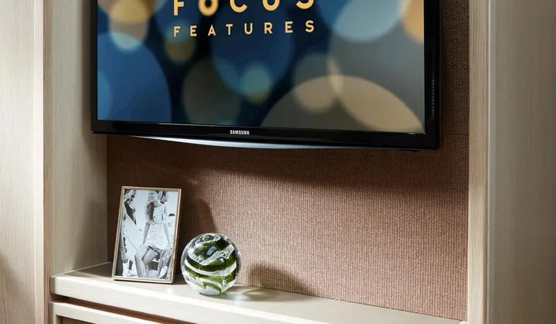  Yacht Photos Pics Modern entertainment setup with Samsung TV, framed photo, and decorative glass orb.