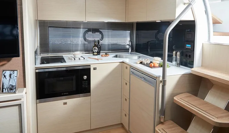  Yacht Photos Pics Modern kitchen in 2025 Princess V40 yacht with sleek appliances and wooden cabinetry.