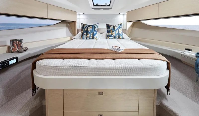  Yacht Photos Pics Luxurious interior of 2025 Princess V40 yacht with elegant bedding and modern decor.
