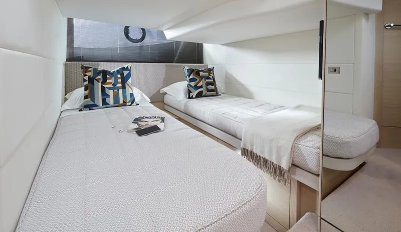 Yacht Photos Pics Luxurious twin cabin interior of 2025 Princess V40 yacht with modern decor and cozy bedding.