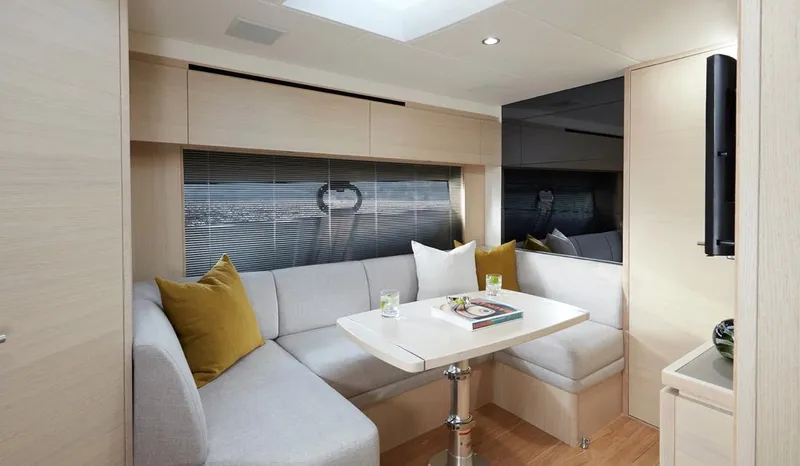  Yacht Photos Pics Modern interior of 2025 Princess V40 yacht with cozy seating and elegant decor.