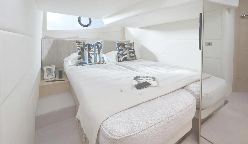  Yacht Photos Pics Luxurious bedroom interior of 2025 Princess V40 yacht with modern decor and cozy bedding.