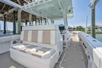  Yacht Photos Pics 2020 Invincible 37' Catamaran interior with cushioned seating and helm station.