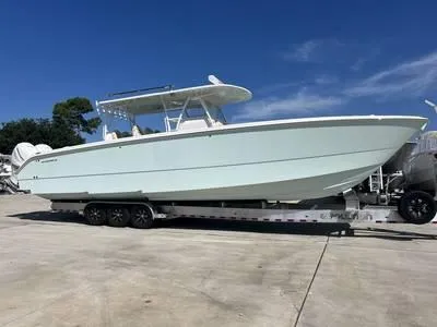  Yacht Photos Pics 2020 Invincible 37' Catamaran on trailer, side view under clear blue sky.
