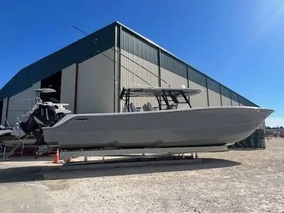  Yacht Photos Pics 2020 Invincible 37' Catamaran docked outside a large storage facility.