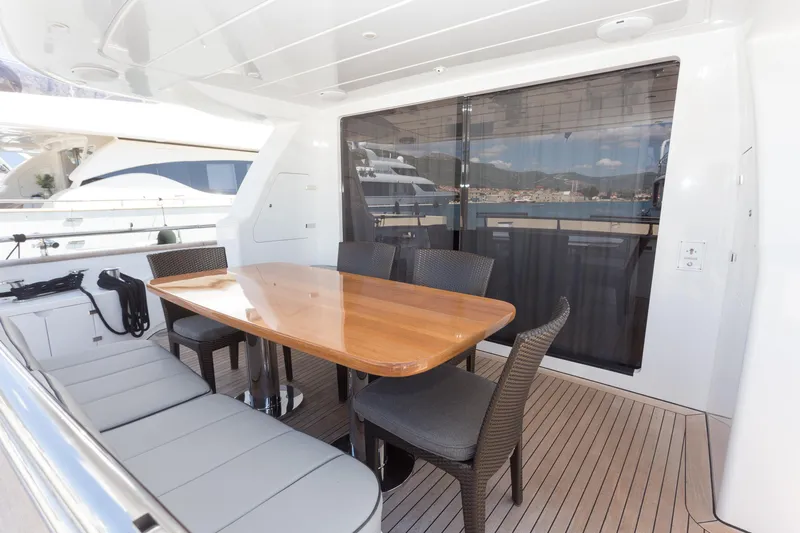  Yacht Photos Pics Luxury yacht Maiora 20S 2008, featuring elegant outdoor dining area with wooden table and chairs.