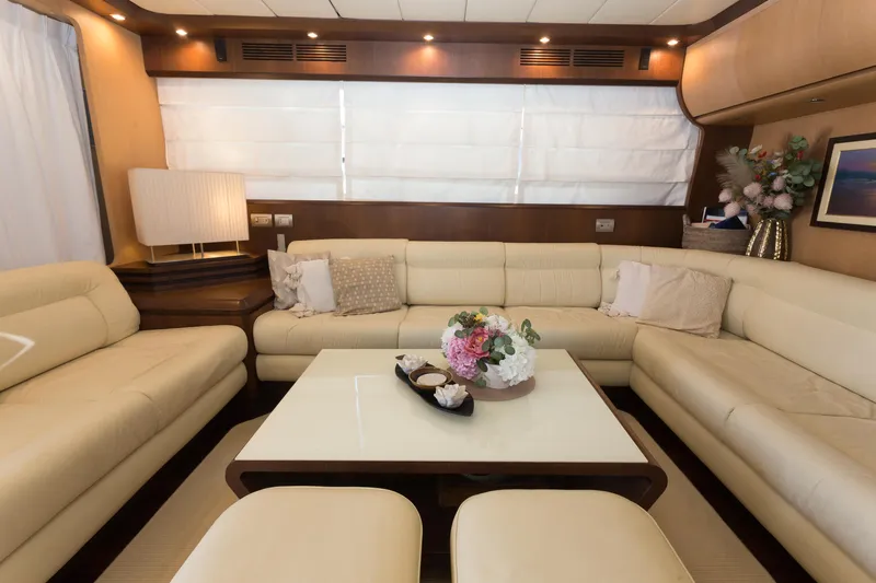  Yacht Photos Pics Luxurious interior of 2008 Maiora 20S yacht with elegant cream sofas and floral centerpiece.