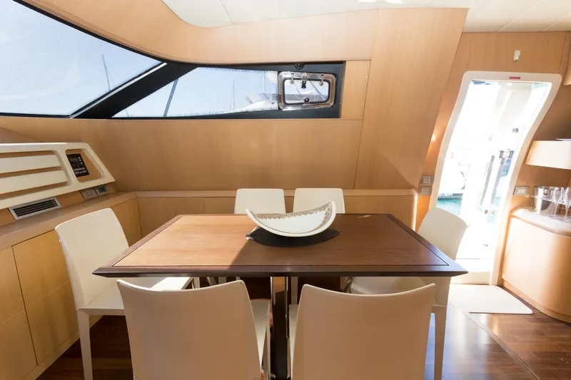  Yacht Photos Pics Luxurious dining area inside 2008 Maiora 20S yacht with modern decor and natural lighting.