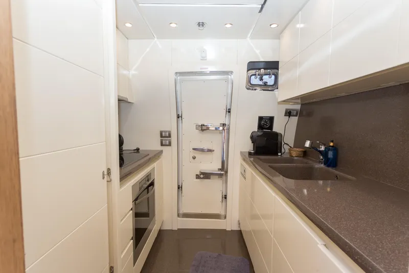  Yacht Photos Pics Modern kitchen interior on 2008 Maiora 20S yacht, featuring sleek countertops and appliances.