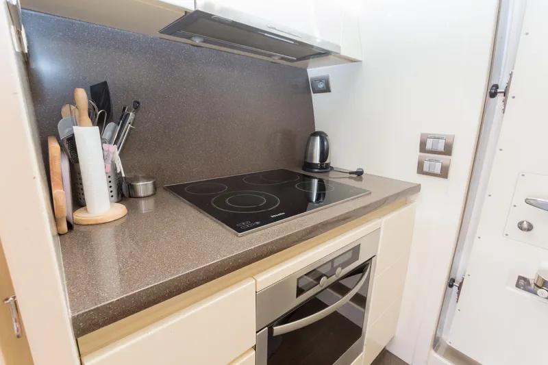  Yacht Photos Pics Compact kitchen in a 2008 Maiora 20S yacht with modern appliances and utensils.