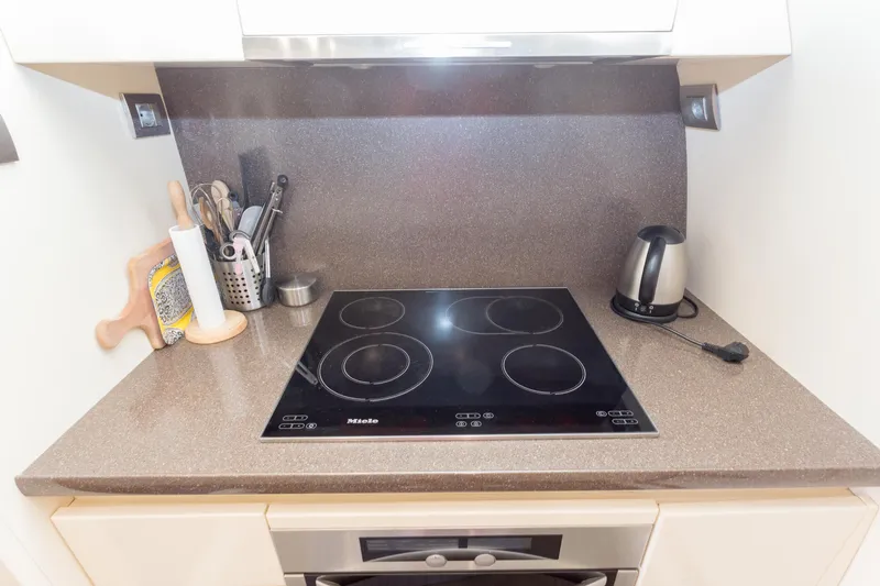  Yacht Photos Pics Modern kitchen with Miele cooktop, kettle, and utensils on a Maiora 20S yacht, 2008 model.