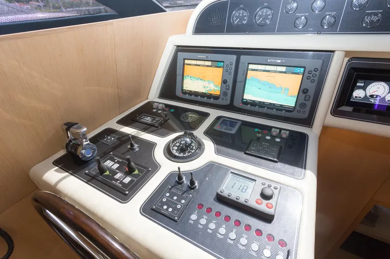  Yacht Photos Pics Control panel of a 2008 Maiora 20S yacht with navigation screens and instruments.