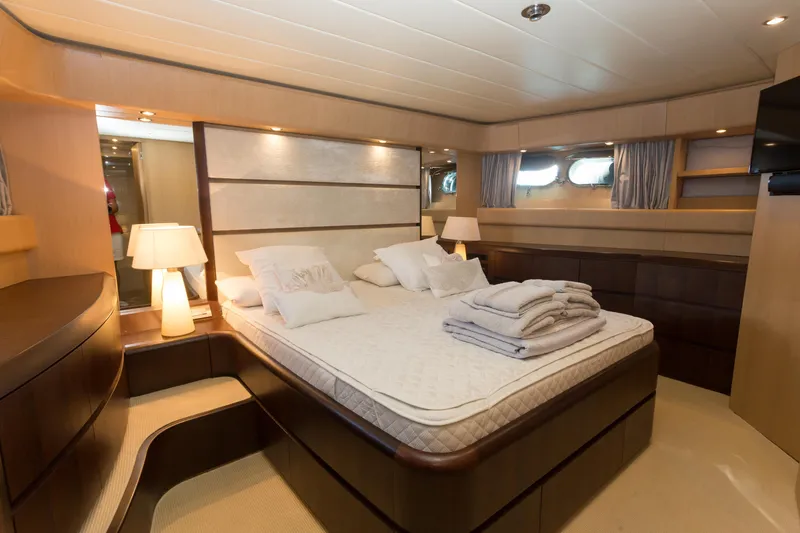  Yacht Photos Pics Luxurious bedroom interior on 2008 Maiora 20S yacht, featuring elegant bedding and ambient lighting.