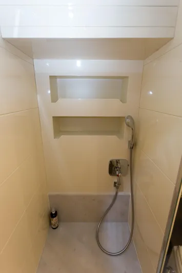  Yacht Photos Pics Compact shower area in a 2008 Maiora 20S yacht with built-in shelves and handheld showerhead.