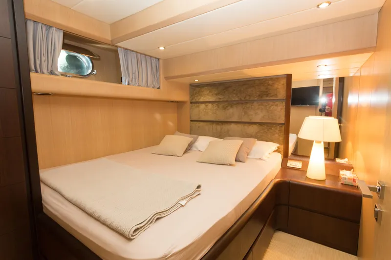  Yacht Photos Pics Luxurious bedroom interior on 2008 Maiora 20S yacht, featuring cozy bed and elegant lighting.
