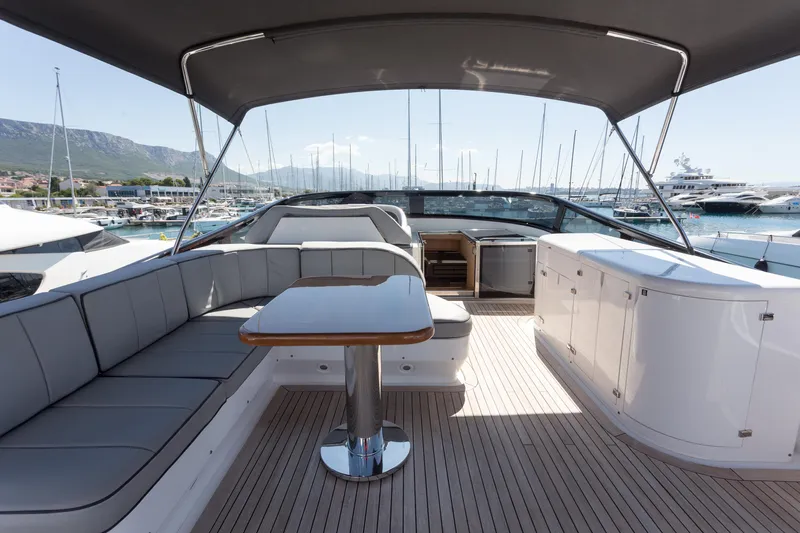  Yacht Photos Pics Luxurious 2008 Maiora 20S yacht interior with seating and table, docked at marina.