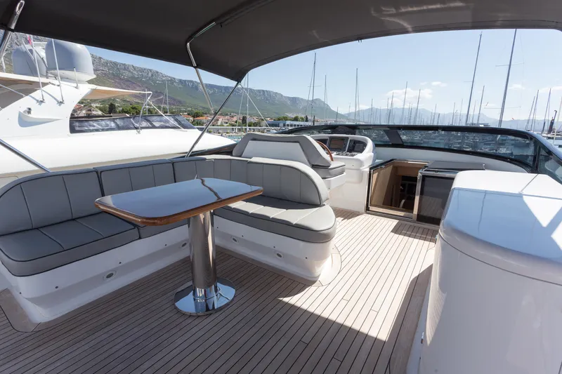  Yacht Photos Pics Luxurious 2008 Maiora 20S yacht deck with seating and table, docked in a marina.