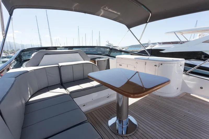  Yacht Photos Pics Luxurious 2008 Maiora 20S yacht deck with seating and table, docked at marina.