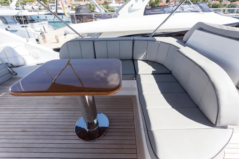  Yacht Photos Pics Luxurious seating area on 2008 Maiora 20S yacht with sleek wooden table.