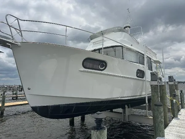  Yacht Photos Pics 2019 Beneteau Swift Trawler 44 docked at marina under cloudy sky.