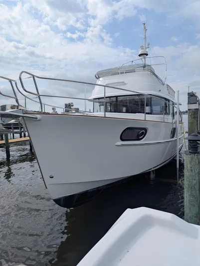  Yacht Photos Pics 2019 Beneteau Swift Trawler 44 docked at marina under cloudy sky.