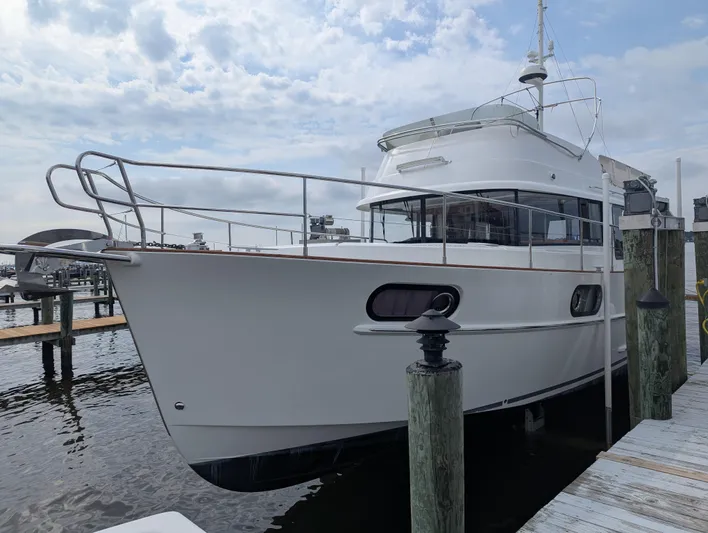  Yacht Photos Pics 2019 Beneteau Swift Trawler 44 docked at marina under cloudy sky.