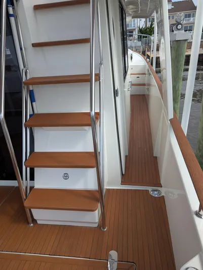  Yacht Photos Pics 2019 Beneteau Swift Trawler 44 deck with wooden stairs and railing.