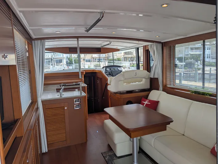  Yacht Photos Pics Interior of 2019 Beneteau Swift Trawler 44, featuring elegant wood finishes and comfortable seating.