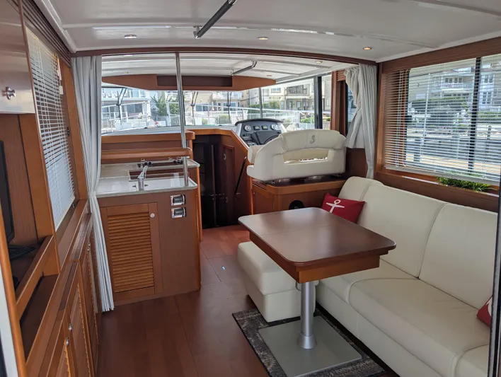  Yacht Photos Pics Interior of 2019 Beneteau Swift Trawler 44, featuring elegant wood finishes and comfortable seating.
