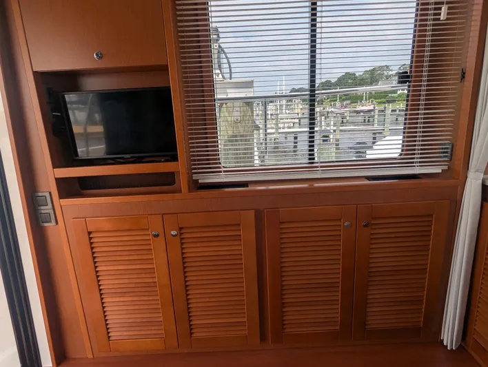  Yacht Photos Pics Interior of 2019 Beneteau Swift Trawler 44 with wooden cabinets and window blinds.