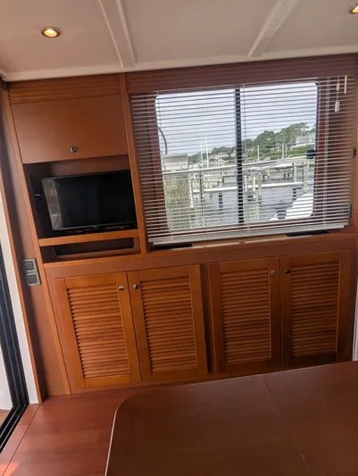  Yacht Photos Pics Interior of 2019 Beneteau Swift Trawler 44 with wooden cabinetry and window blinds.