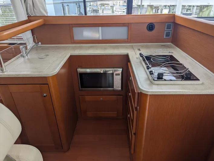 Yacht Photos Pics 2019 Beneteau Swift Trawler 44 kitchen with stove, sink, and microwave.