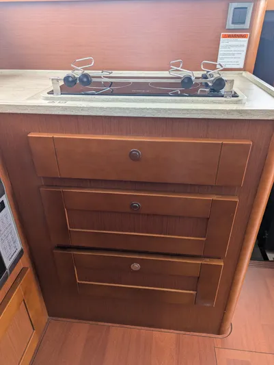  Yacht Photos Pics 2019 Beneteau Swift Trawler 44 kitchen with stove and wooden cabinetry.
