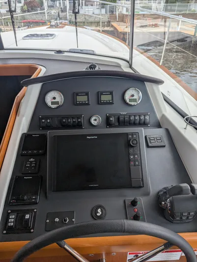  Yacht Photos Pics 2019 Beneteau Swift Trawler 44 helm with navigation controls and instruments.